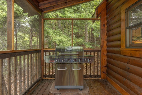 Gas grill on a screened in porch at Location Location Location, a 1 bedroom cabin rental located in Pigeon Forge
