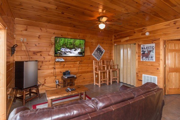 Mini fridge and large TV in the game room at Ella-Vation, a 3 bedroom cabin rental located in Gatlinburg