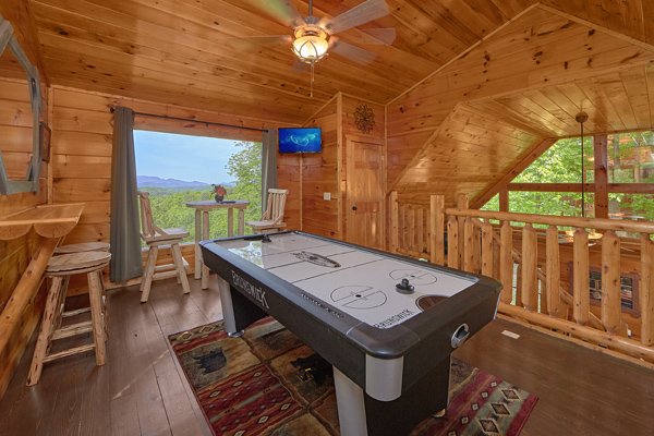 Air hockey table in the game loft at Makin' Honey, a 1 bedroom cabin rental located in Pigeon Forge