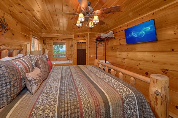 Bedroom with a television at Makin' Honey, a 1 bedroom cabin rental located in Pigeon Forge