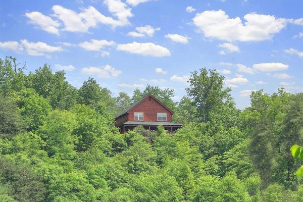 Looking back at the cabin in the trees at Pigeon Forge View, a 6 bedroom cabin rental located in Pigeon Forge