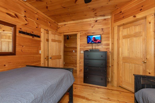 Double bedroom with dresser and TV at Pigeon Forge View, a 6 bedroom cabin rental located in Pigeon Forge