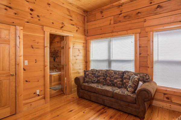Sleeper sofa in a bedroom at Pigeon Forge View, a 6 bedroom cabin rental located in Pigeon Forge