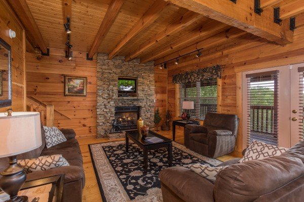 Living room with a fireplace and TV at Pigeon Forge View, a 6 bedroom cabin rental located in Pigeon Forge