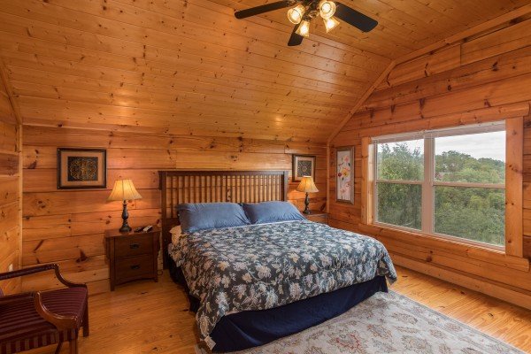 Bedroom with a bed, night stands, and lamps at Pigeon Forge View, a 6 bedroom cabin rental located in Pigeon Forge