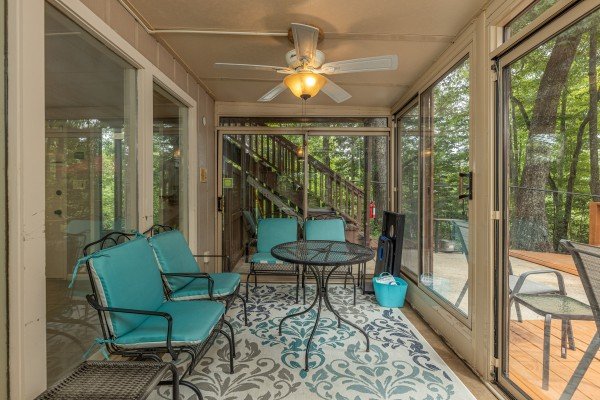 Seating area on screened in porch at Buena Vista Getaway, 3 bedroom cabin rental located in Gatlinburg