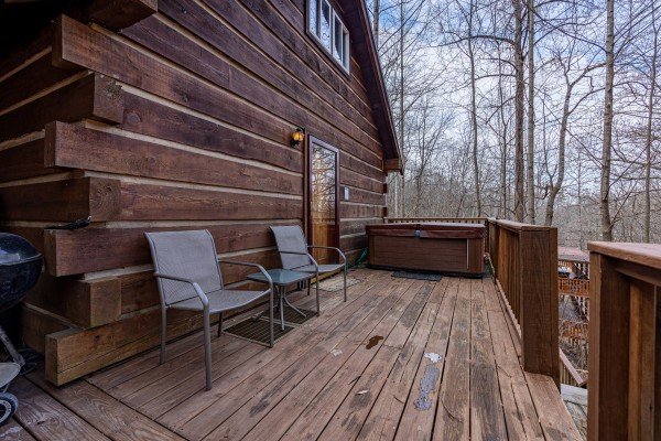 Deck seating and entrance at Henwood's Hideaway, a 1 bedroom cabin rental located in Pigeon Forge