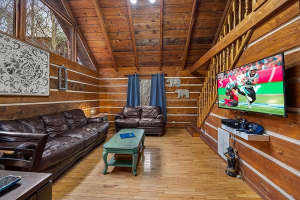Living room flat screen and seating  at Henwood's Hideaway, a 1 bedroom cabin rental located in Pigeon Forge
