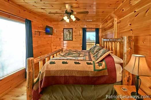 First floor bedroom with king bed at Tree Top Lodge, a 3 bedroom cabin rental located in Gatlinburg