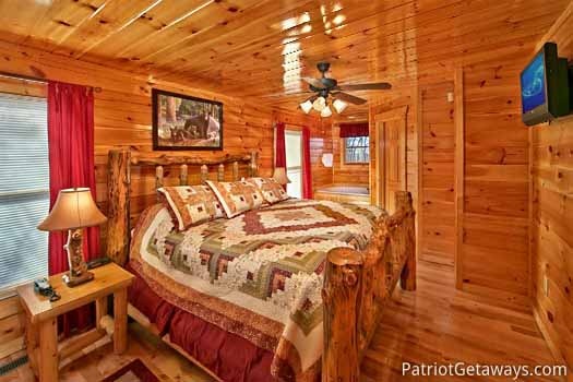 Main level bedroom with king bed at Tree Top Lodge, a 3 bedroom cabin rental located in Gatlinburg
