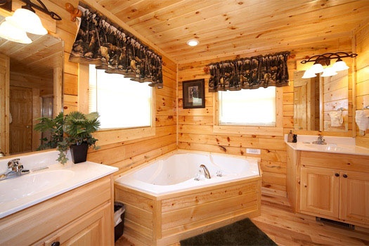 Jacuzzi tub in master bathroom with separate vanity sinks Big Bear Cove, a 3-bedroom rental located in Gatlinburg