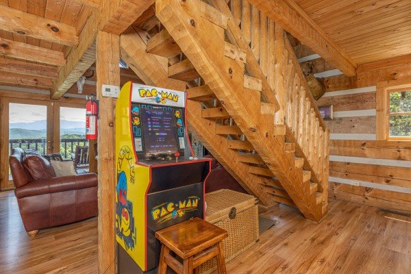 Pacman arcade game and staircase at A Room With A View, a 1 bedroom cabin rental located in Pigeon Forge