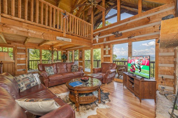 Living room, seating, and TV at A Room With A View, a 1 bedroom cabin rental located in Pigeon Forge