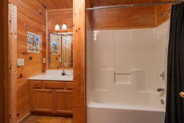 Bathroom with a tub and shower at Lumber Jack Lodge, a 1 bedroom cabin rental located in Gatlinburg