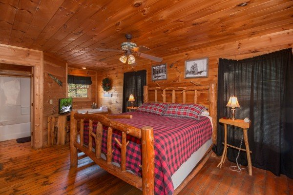 Bedroom with a log bed, night stands, and lamps at Lumber Jack Lodge, a 1 bedroom cabin rental located in Gatlinburg