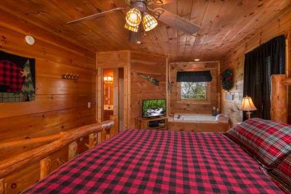 TV and jacuzzi in a bedroom at Lumber Jack Lodge, a 1 bedroom cabin rental located in Gatlinburg