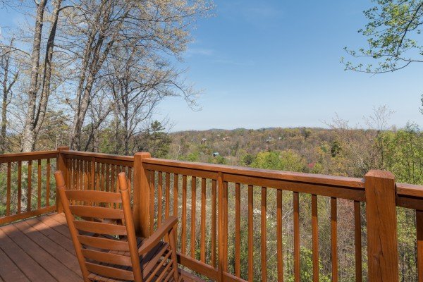 Rocking chair on a deck at Lumber Jack Lodge, a 1 bedroom cabin rental located in Gatlinburg