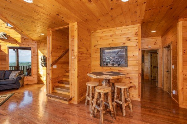 High table with seating for four at Four Seasons Palace, a 5-bedroom cabin rental located in Pigeon Forge