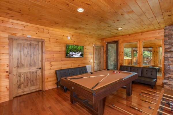 Pool table in the game room at Four Seasons Palace, a 5-bedroom cabin rental located in Pigeon Forge