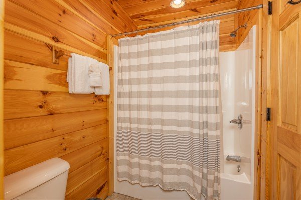 Bathroom with a tub and shower at Pinot Paradise, a 3 bedroom cabin rental located in Pigeon Forge