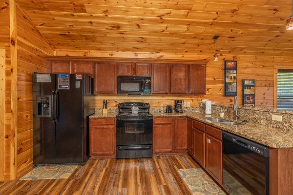 Kitchen with black appliances at Pinot Paradise, a 3 bedroom cabin rental located in Pigeon Forge