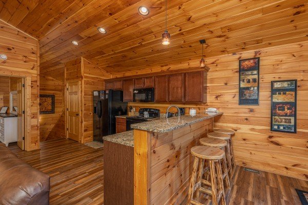 Kitchen with a breakfast bar at Pinot Paradise, a 3 bedroom cabin rental located in Pigeon Forge