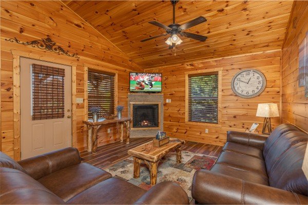 Living room with fireplace and TV at Pinot Paradise, a 3 bedroom cabin rental located in Pigeon Forge