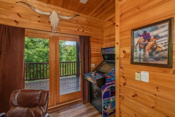 Arcade game in the game room at God's Country, a 4 bedroom cabin rental located in Pigeon Forge
