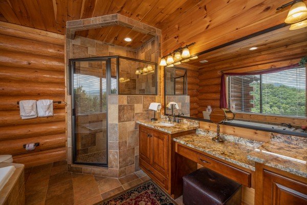Bathroom with a jacuzzi, separate shower, and double vanity sinks at God's Country, a 4 bedroom cabin rental located in Pigeon Forge