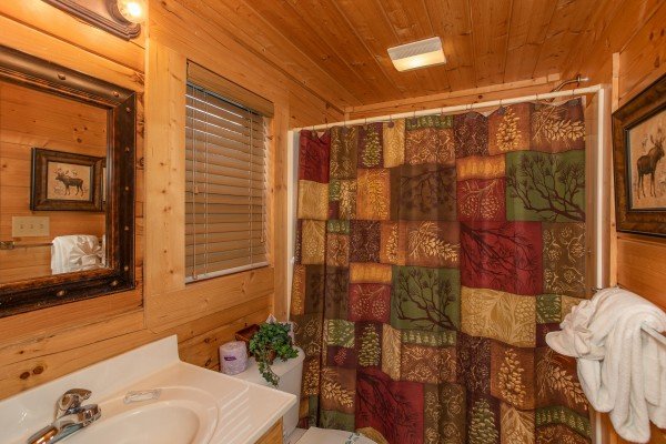 Bathroom with a tub and shower at Let the Good Times Roll, a 2 bedroom cabin rental located in Pigeon Forge