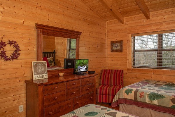 Dresser and TV in the upstairs bedroom at Let the Good Times Roll, a 2 bedroom cabin rental located in Pigeon Forge