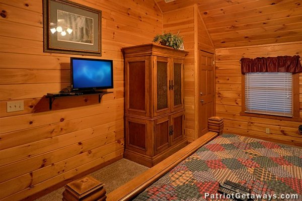 TV and armoire in the bedroom at The Big View, a 4 bedroom cabin rental located in Pigeon Forge