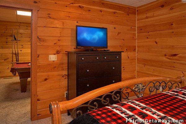 Bedroom with dresser and TV at The Big View, a 4 bedroom cabin rental located in Pigeon Forge