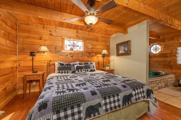 Bedroom with a king bed, two night stands, and lamps at Golden Memories, a 1 bedroom cabin rental located in Pigeon Forge