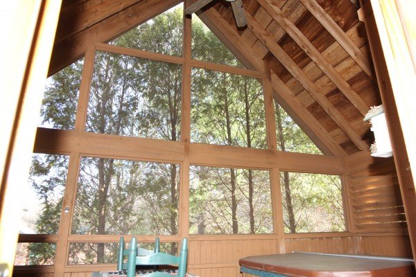 Screened in porch with a vaulted ceiling at Golden Memories, a 1-bedroom cabin rental located in Pigeon Forge