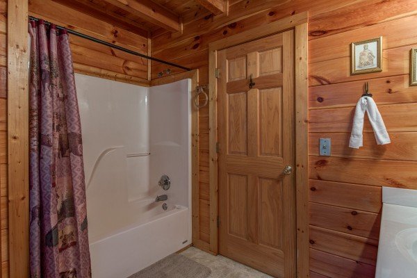 Bathroom with a tub and shower at A Honeymoon Haven, a 1 bedroom cabin rental located in Gatlinburg