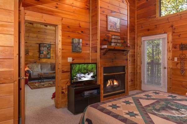TV and fireplace in a bedroom at A Honeymoon Haven, a 1 bedroom cabin rental located in Gatlinburg