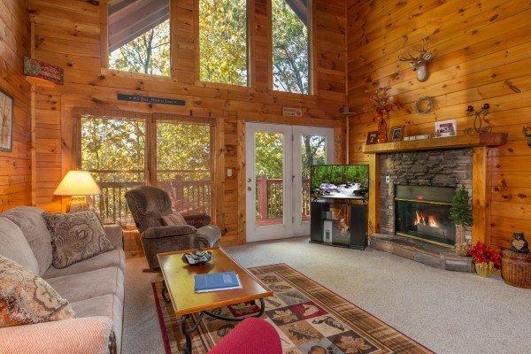 Living room with fireplace and TV at A Honeymoon Haven, a 1 bedroom cabin rental located in Gatlinburg