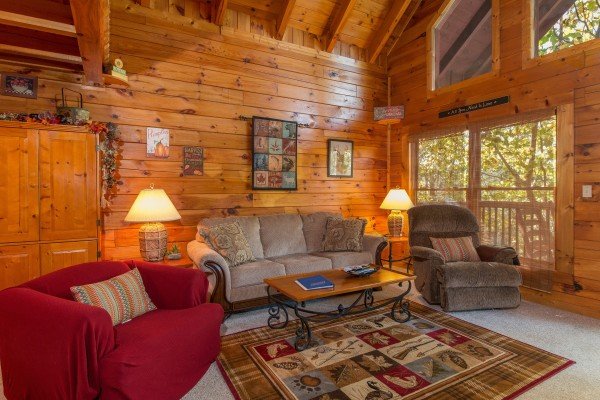 Seating in the living room at A Honeymoon Haven, a 1 bedroom cabin rental located in Gatlinburg