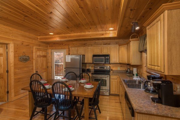 Dining table for six in the kitchen at 5 Little Cubs, a 2 bedroom cabin rental located in Pigeon Forge