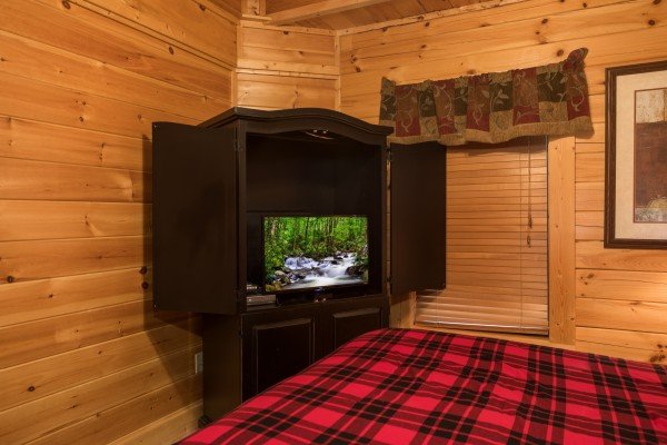 TV and armoire in a bedroom at 5 Little Cubs, a 2 bedroom cabin rental located in Pigeon Forge