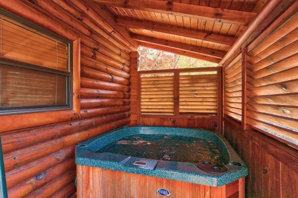 Hot tub with privacy fence at 5 Little Cubs, a 2 bedroom cabin rental located in Pigeon Forge