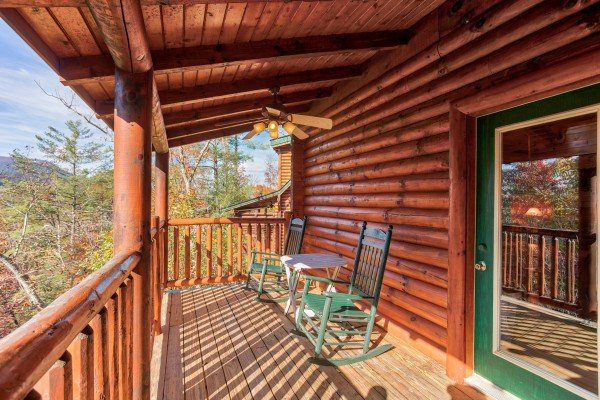 Rocking chairs on a covered deck at 5 Little Cubs, a 2 bedroom cabin rental located in Pigeon Forge