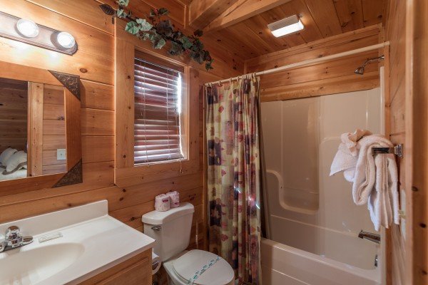 Bathroom with a tub and shower at 5 Little Cubs, a 2 bedroom cabin rental located in Pigeon Forge