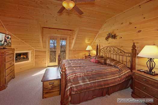 Third floor bedroom with king sized bed fireplace and tv at Alpine Pointe, a 5 bedroom cabin rental located in Gatlinburg