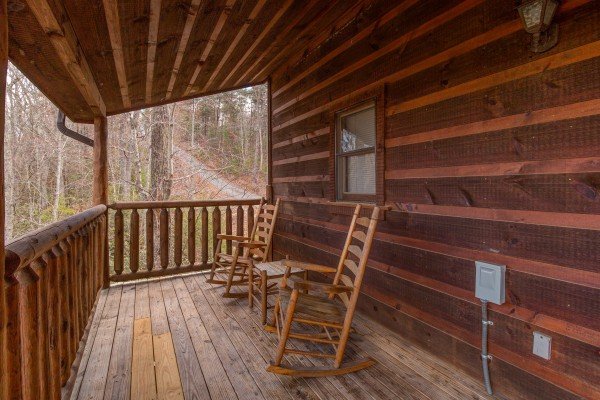 Rocking chairs on a covered deck at Moonshine Memories, a 2 bedroom cabin rental located in Gatlinburg