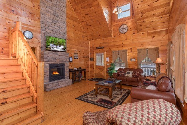 Living room with fireplace and TV at Moonshine Memories, a 2 bedroom cabin rental located in Gatlinburg