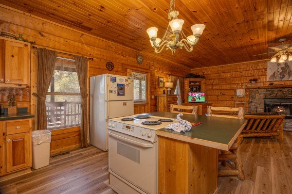 Stove and breakfast nook at Mountain Magic, a 1 bedroom cabin rental located in Pigeon Forge