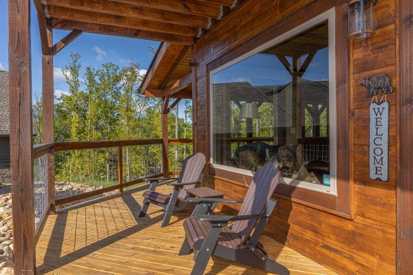 Adirondack chairs on a covered deck at Heaven's Hill, a 3 bedroom cabin rental located in Gatlinburg