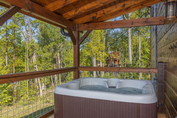 Hot tub on a covered deck at Heaven's Hill, a 3 bedroom cabin rental located in Gatlinburg
